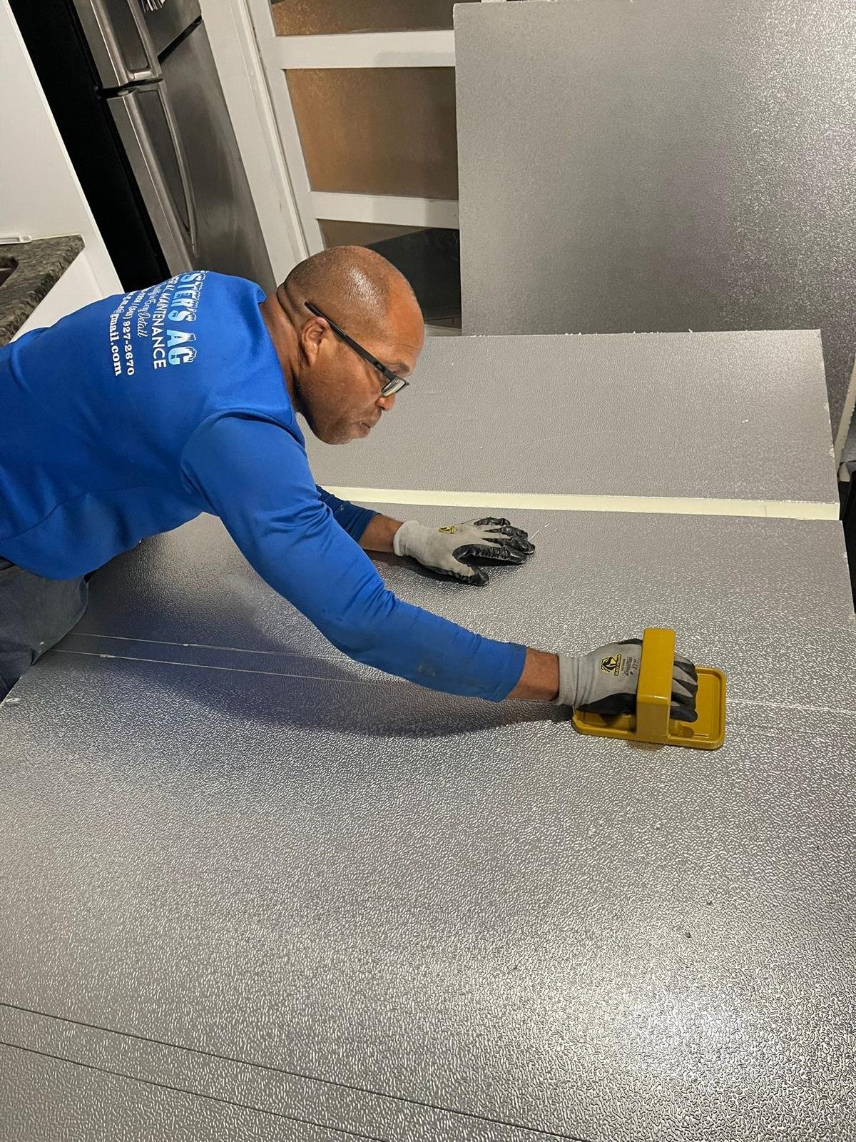 AC technician performing maintenance on an air conditioning unit